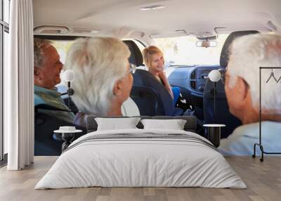 Group Of Senior Friends Sitting In Car Driving To Vacation Wall mural