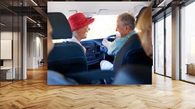 Group Of Senior Friends Sitting In Car Driving To Vacation Wall mural