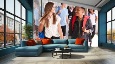 Group Of Smiling Male And Female College Students Walking In School Building Corridor Wall mural