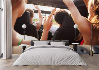 Group Of Young Friends Dancing In Back Of Open Top Car Wall mural