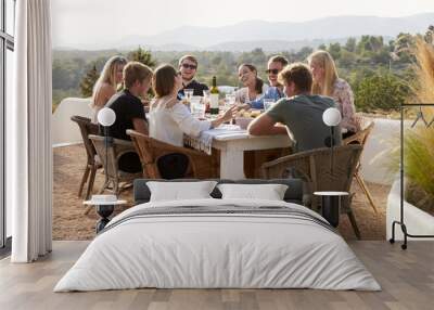 Group Of Young Friends Enjoying Outdoor Meal On Holiday Wall mural