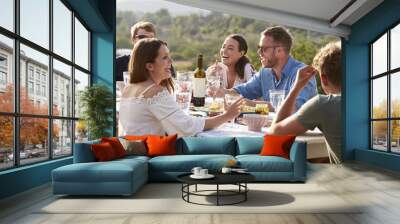 Group Of Young Friends Enjoying Outdoor Meal On Holiday Wall mural