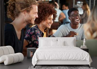 Group Of Young Friends Meeting For Drinks And Food In Restaurant Wall mural