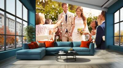 Guests Throwing Confetti Over Bride And Groom At Wedding Wall mural