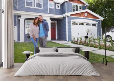 Happy black couple standing outside their house Wall mural