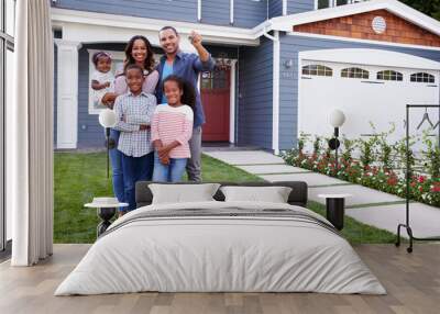 Happy black family standing outside their house, dad holding the Wall mural