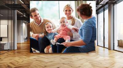 Health Visitor Talking To Family With Young Baby Wall mural