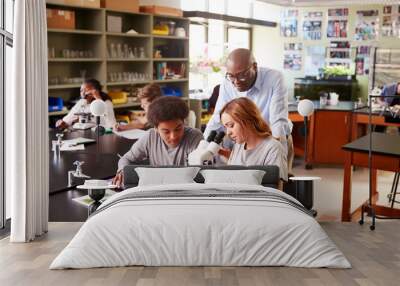 High School Students With Tutor Using Microscope In Biology Class Wall mural