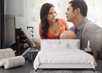 Hispanic couple and baby in home office Wall mural