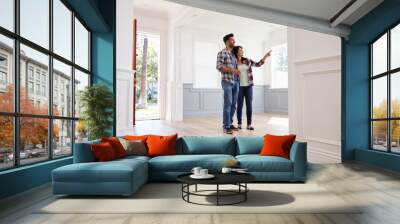 Hispanic Couple Viewing Potential New Home Wall mural