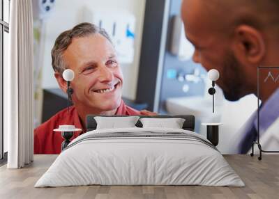 Male Patient Being Reassured By Doctor In Hospital Room Wall mural