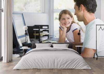 Man and young girl in home office with computer smiling Wall mural