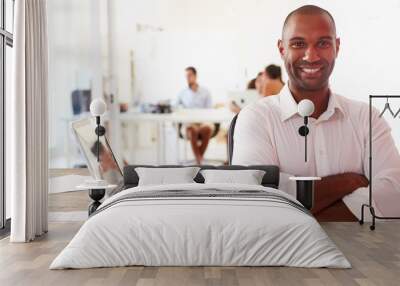 man using laptop in modern office of start up business Wall mural