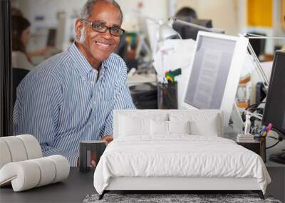 Man Working At Desk In Busy Creative Office Wall mural