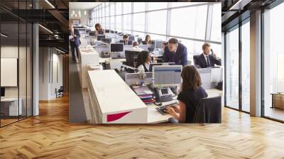 Manager in discussion with coworker in an open plan office Wall mural