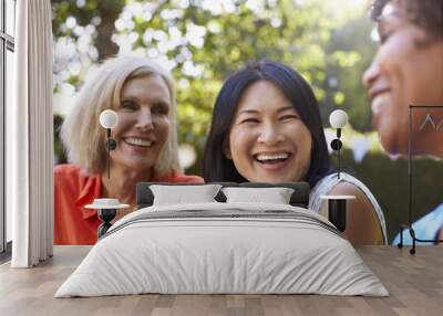 Mature Female Friends Socializing In Backyard Together Wall mural