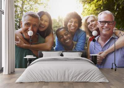 mature friends giving piggybacks in backyard together Wall mural