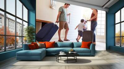 Mid adult white couple and kids leaving their home with luggage to go on vacation, full length Wall mural