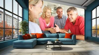 mid age couples chatting at home Wall mural