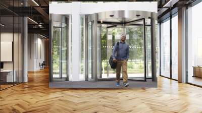 middle aged black man entering the foyer of modern building Wall mural