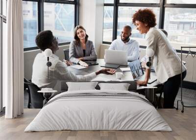 Millennial black businesswoman stands listening to corporate colleagues at a meeting, close up Wall mural