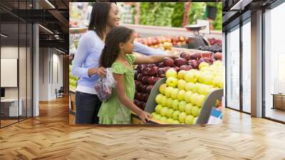 mother and daughter in produce section Wall mural