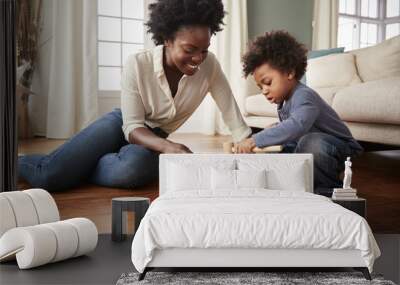 Mother And Young Son Playing With Wooden Toy At Home Wall mural