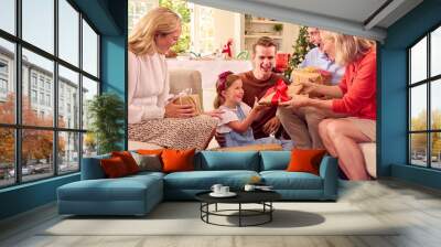 Multi-Generation Family Celebrating Christmas At Home Opening Presents Together Wall mural