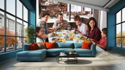 Multi Generation Family Enjoying Meal Around Table At Home Together Wall mural