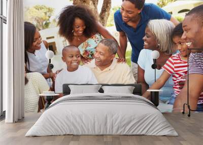 Multi Generation Family Enjoying Meal In Garden Together Wall mural