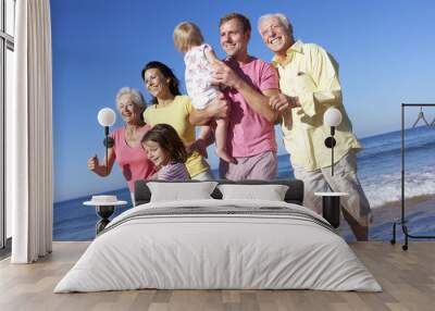 Multi Generation Family Running Along Beach Together Wall mural