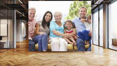 Multi Generation Family Sitting On Garden Seat Wall mural