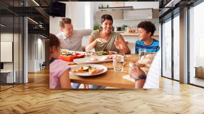 Multi-Generation Mixed Race Family Eating Meal Around Table At Home Together Wall mural