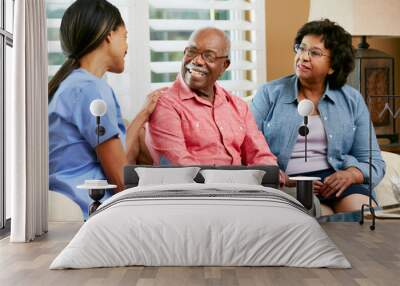 nurse making notes during home visit with senior couple Wall mural