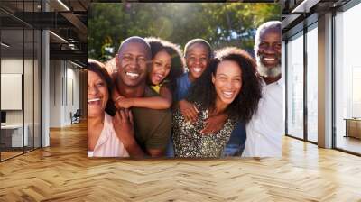 Outdoor Portrait Of Multi-Generation Family In Garden At Home Against Flaring Sun Wall mural