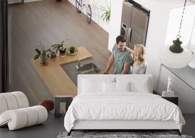 Overhead View Of Couple Looking At Laptop In Modern Kitchen Wall mural