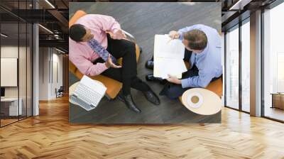 overhead view of two businessmen having meeting in office lobby Wall mural