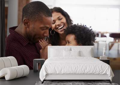 Parents Playing With Young Daughter At Home Wall mural