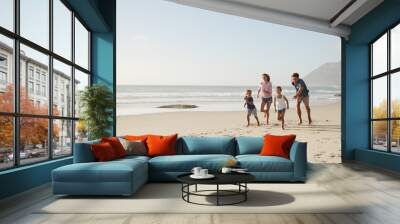 Parents Running Along Beach With Children On Summer Vacation Wall mural