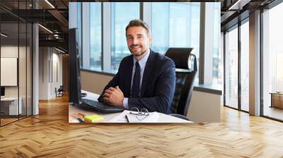 Portrait Of Businessman At Office Desk Using Computer Wall mural