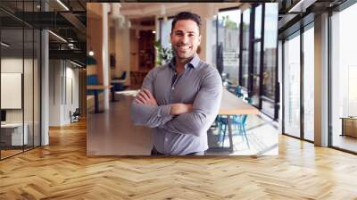 Portrait Of Businessman Standing In Modern Open Plan Office Wall mural