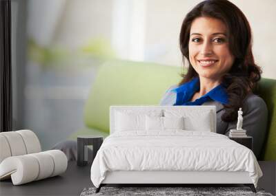 Portrait Of Businesswoman Sitting On Sofa In Modern Office Wall mural