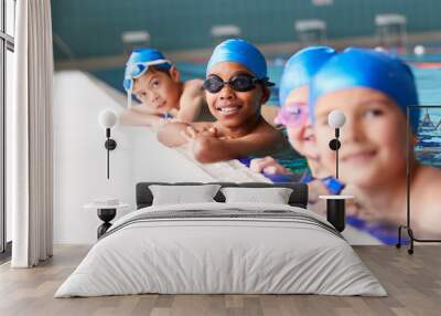 Portrait Of Children In Water At Edge Of Pool Waiting For Swimming Lesson Wall mural