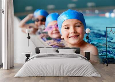 Portrait Of Children In Water At Edge Of Pool Waiting For Swimming Lesson Wall mural