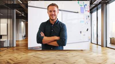 portrait of confident caucasian male teacher in classroom Wall mural