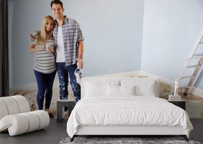 Portrait Of Couple Decorating Nursery For New Baby Wall mural