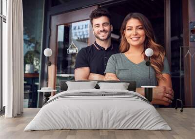 Portrait Of Couple Starting New Coffee Shop Or Restaurant Business Standing In Doorway Wall mural