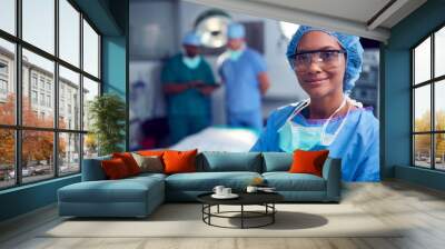 Portrait Of Female Surgeon Wearing Scrubs And Protective Glasses In Hospital Operating Theater Wall mural