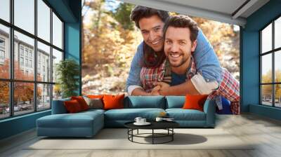 Portrait Of Gay Male Couple Walking Through Fall Woodland Wall mural