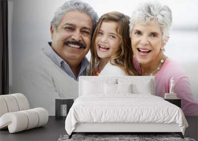 Portrait Of Grandparents On Beach With Granddaughter Wall mural